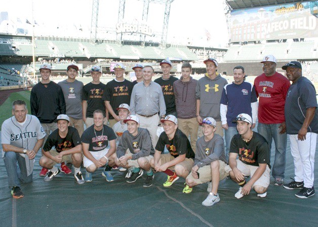 The Thomas Jefferson High School varsity baseball team and King County Councilman Pete von Reichbauer are joined on the Safeco Field diamond by Seattle Mariners Manager Lloyd McClendon and Seattle Seahawks great Jim Zorn on Sept. 13.