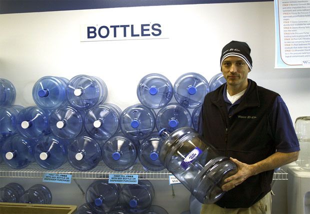 Water to Go co-owner David Payne shows refillable water jugs. Between June 1 and Thursday