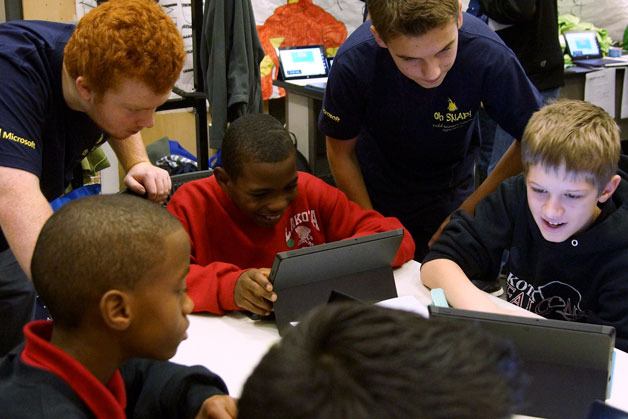 Todd Beamer High School students help Lakota Middle School students learn about technology.