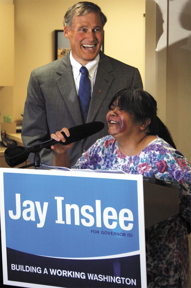 Democrat Jay Inslee and local citizen activist Regina Owens are seen at Dr. Ted Bridges’ office in Federal Way on Sept. 20. Inslee