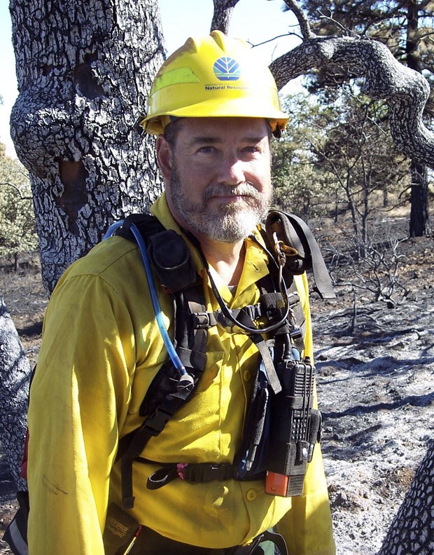 Doug Chamberlain cleans up after a blaze that burned in Klickitat County this past summer. Chamberlain worked on a wildland firefighting crew with the Department of Natural Resources. He chose to pursue firefighting after 18 years as a pastor.
