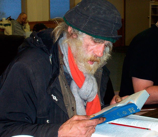 A homeless man reads at New Hope Church in Federal Way
