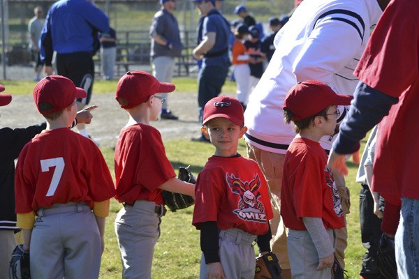Members of the Owlz Federal Way National T-Ball team wait patiently to take part in the jamboree ceremonies Saturday at the league's complex. The jamboree included all the team from Federal Way National.