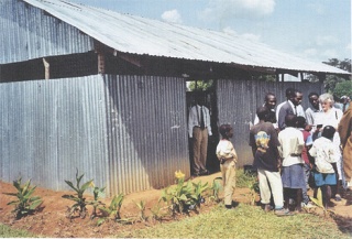 Bishop Lawrence Ochieng Halonda stands in the doorway of a church in Kenya.
