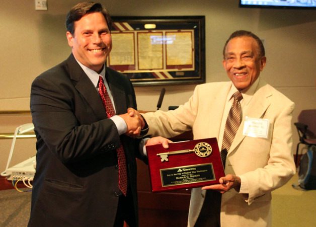 Mayor Jim Ferrell (left) presents Harold Booker with the mayor’s “Key to the City” for his outstanding leadership and commitment to human rights