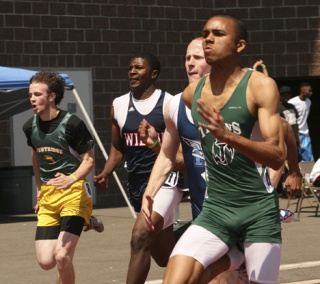 Beamer senior Duran Ward (right) runs a preliminary heat in the 100-meter dash Friday at the West Central District Championships at Mount Tahoma High School. Ward finished second in the 100 and won the 200 district title.