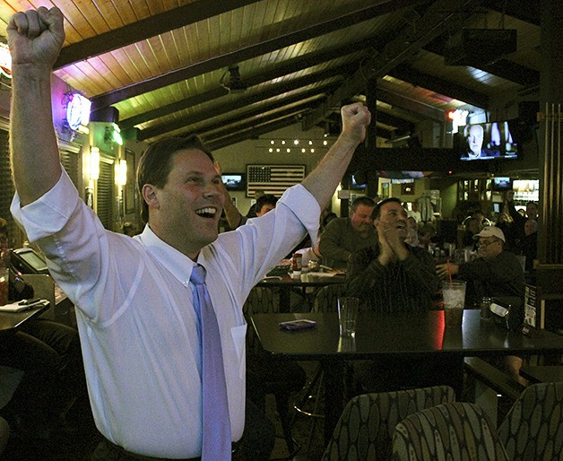 Jim Ferrell reacts to the initial election results that show him leading Skip Priest in Federal Way's mayoral race Tuesday night. His campaign gathered at Time Out Alehouse.