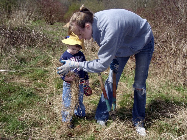 A mother and son help at a recent EarthCorps volunteer event.