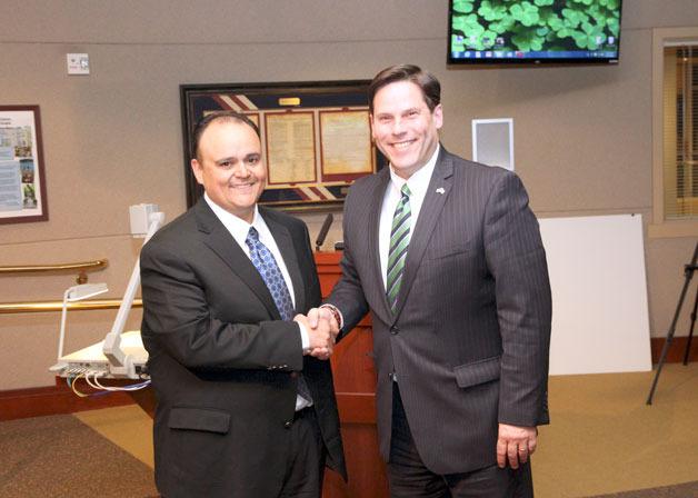 Federal Way Mayor Jim Ferrell (right) shakes hands with Michael Morales