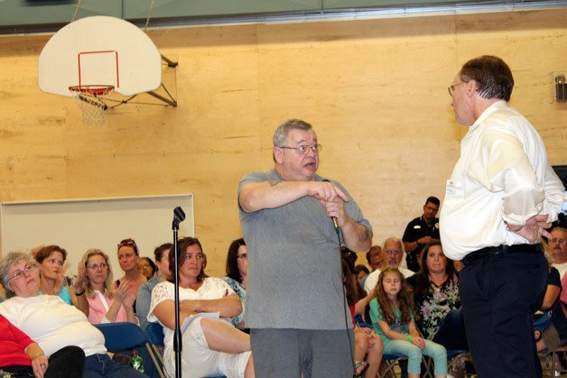 A concerned community member sounds off in a packed gymnasium at Woodmont K-8 on Tuesday night