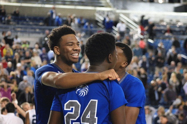 Christian Jones celebrates with teammates Palofino Jatta and Etan Collins after Federal Way's 46-44 win in the state semifinals over Gonzaga Prep on March 4