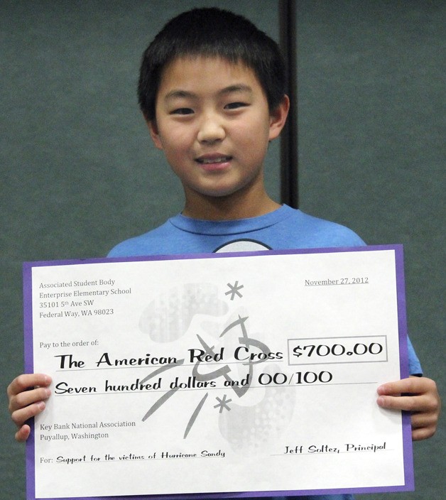 Enterprise Elementary School fifth-grader Zachary Yoon helped lead the coin drive. At a school assembly Nov. 27