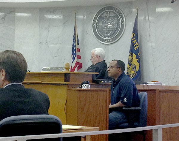 Tony Moore sits at the witness stand during cross-examination for his trial on Thursday