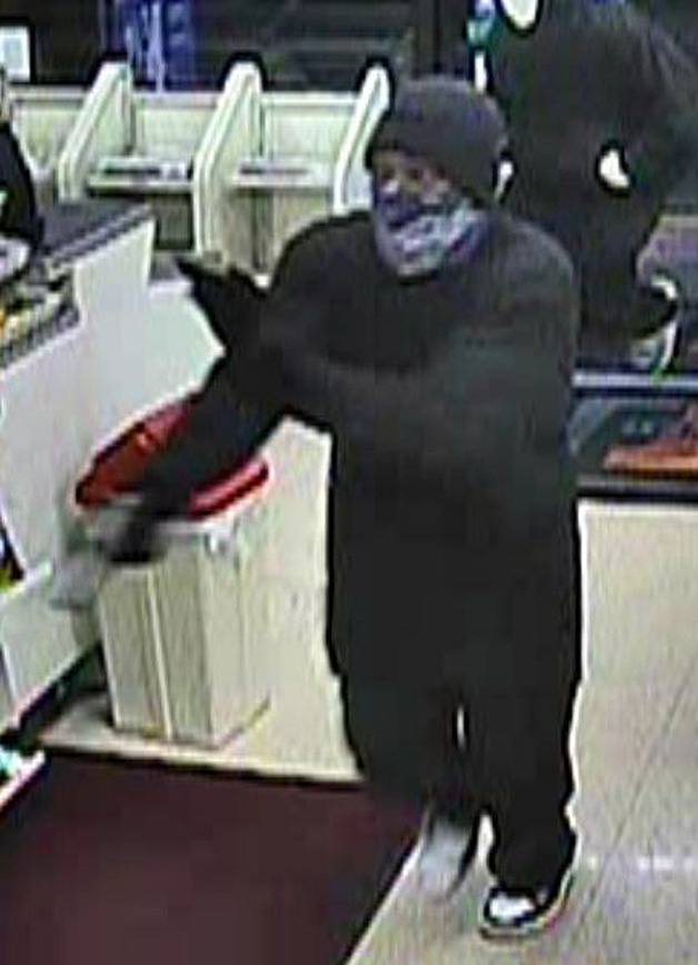 Surveillance footage of an armed robbery suspect