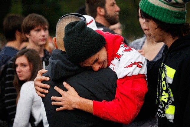 Keith Pablo reunites with friends and family outside of Shoultes Christian Assembly just northwest of Marysville Pilchuck High School in Marysville on Friday afternoon. Students were evacuated by bus to the location after a shooting at the school.