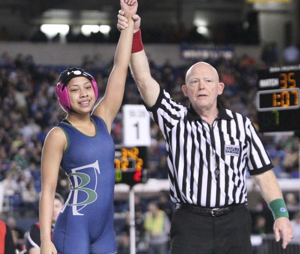 Beamer sophomore Arian Carpio has her hand raised after winning the 2013 state wrestling championship at 112 pounds inside the Tacoma Dome. Carpio also added a national championship recently.