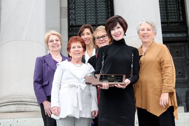 Peggy LaPorte (second from right holding a plaque) was recognized as the Washingtonian of the Year by the Association of Washington Generals during an event in Olympia on Wednesday. The founder of FUSION