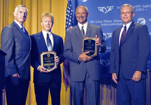 Captain Steve Cleary of Federal Way (second from left) and First Officer Michael Hendrix received their Superior Airmanship awards on Aug. 18 at a banquet in Washington