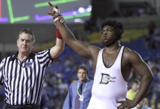 Decatur High School senior Tevyn Tillman gets his hand raised by the referee after beating Anacortes' Bryant Dickerson to win the 285-pound state championship at Class 4A Mat Classic XXI inside the Tacoma Dome Saturday night. It was Tillman's second 285-pound title.