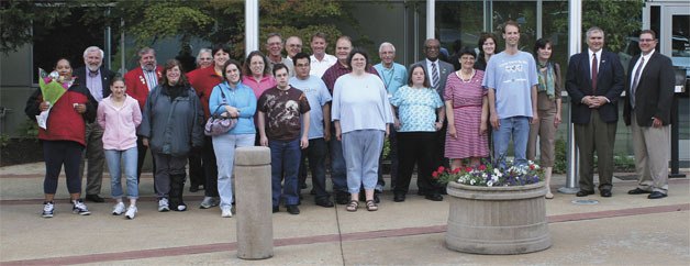 The Aktion Club and Kiwanis members stand outside City Hall on July 19 after receiving the club charter and Kiwanis pins.