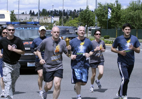 Federal Way law enforcement personnel participate in a torch run to benefit Special Olympics Washington on June 4. The group jogged from South 272nd Street down Pacific Highway to South 373rd Street holding the Flame of Hope.