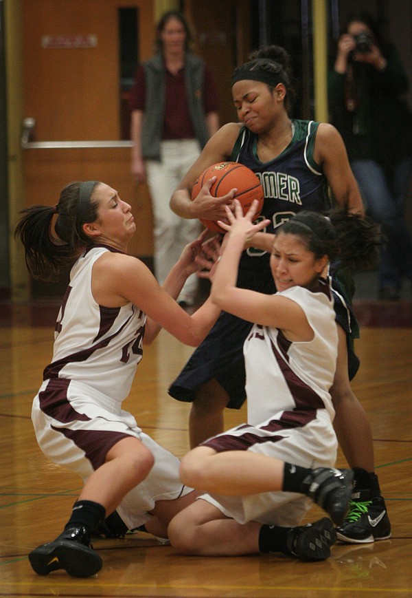 Todd Beamer senior guard Shyla Akins battles with two South Kitsap defenders during Tuesday's loss to the Wolves
