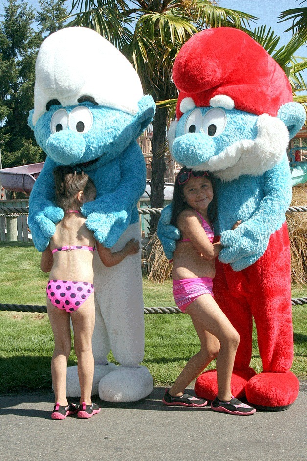 Papa Smurf and Clumsy hug Wild Waves guests at the theme park's entrance on Wednesday morning.