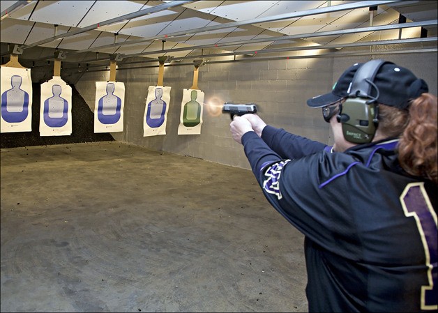 Stephanie Taylor participates in a live-fire practice with the Armed Defense Training Association earlier this month at the Federal Way Discount Guns indoor shooting range.