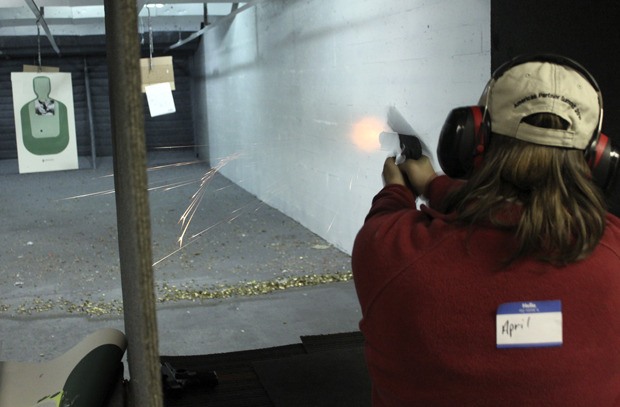 Federal Way resident April Hiatt fires at her target Thursday at Bull’s Eye shooting range in Tacoma. Hiatt and her husband