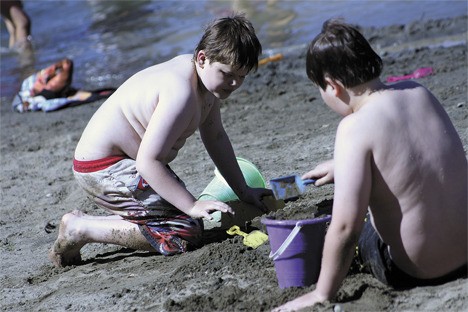 Nolan Scott plays in the sand Wednesday at Steel Lake Park. A record high of 90 degrees was set July 7 at Sea-Tac airport