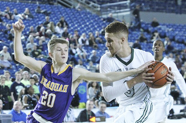 Todd Beamer senior Trey Burch-Manning drives to the basket against an Issaquah defender during Saturday's third/fifth game at the 2014 Class 4A Hardwood Classic inside the Tacoma Dome.