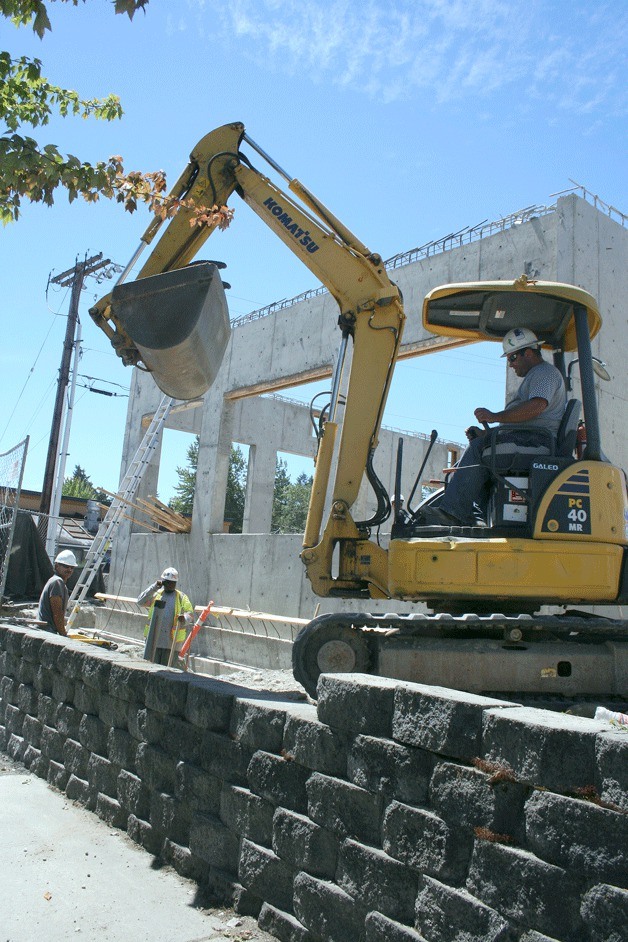 Construction workers make progress on a low-income senior housing complex on Pacific Highway