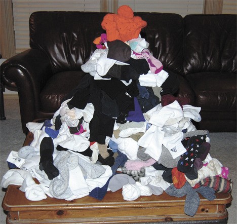 I raked my family’s (clean) socks up from my bedroom floor (the sorting area) and deposited them onto a table. This action formed a shocking 4-foot-tall quivering unpaired sock mountain.