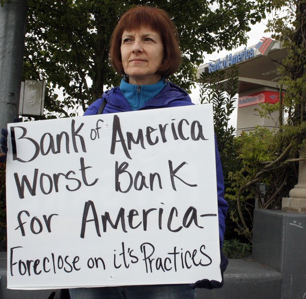 Diane Dobrowolski protests May 9 at the corner of South 320th Street and Pacific Highway South in Federal Way. 'Bank of America epitomizes what corporate America does to the middle class