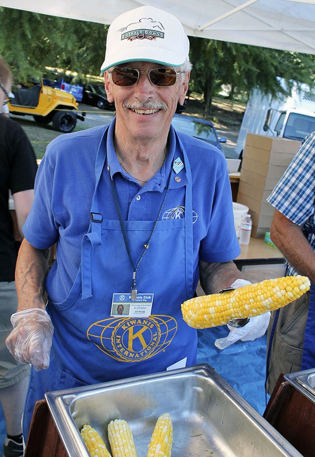 Jim Knapp serves corn on the cob at the 2013 Salmon Bake