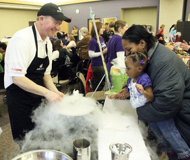 Sub Zero ice cream owner Jack Walsh dazzles a young girl at the Best of Federal Way awards event March 13.
