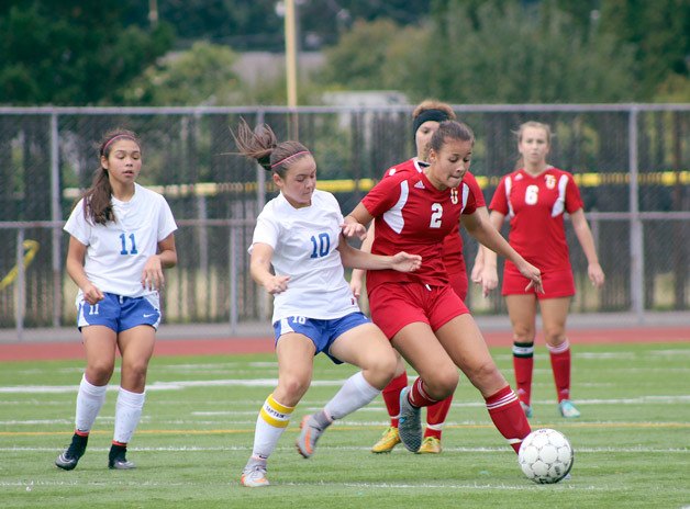 Federal Way's Hannah Kimura (left) and Thomas Jefferson's Kiersten Madsen (right) jostle for the ball during their 2-2 tie on Saturday at Federal Way Memorial Stadium.