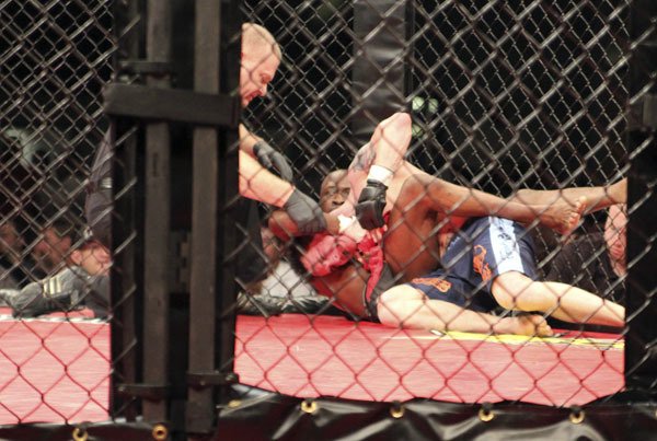 Kirkland fighter Chanti Johnson forces the tapout on Branden Hempleman as the ref stops their fight during the Cagesport MMA event May 15 at Emerald Queen Casino.