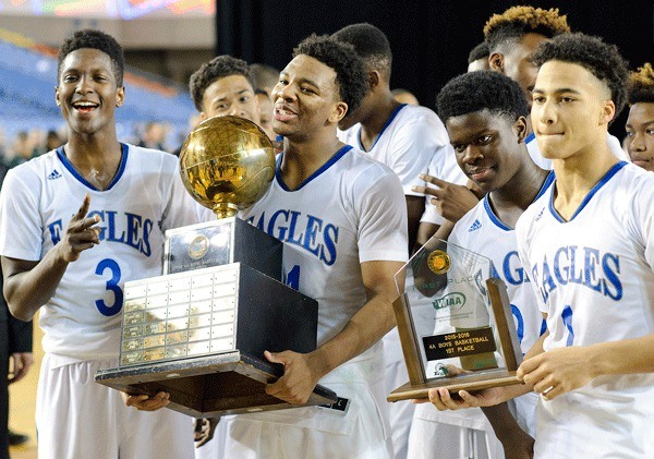 Federal Way players hold their state championship trophies after defeating Kentwood 66-54 on March 5 at the Tacoma Dome. The Eagles have won the last two 4A boys basketball state championships.