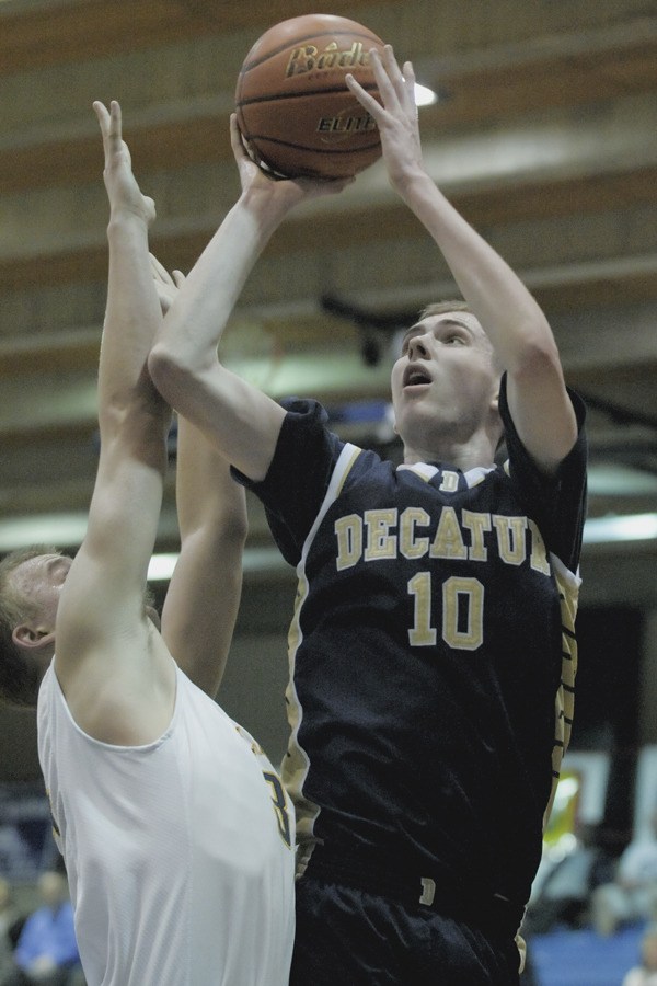 Decatur senior Austen Wilson goes up for a shot over a Bellevue High School defender during Friday's 80-45 loss in the opening round of the Class 3A State Tournament at Bellevue College. It was the Gators' fifth-straight trip to the state tournament.