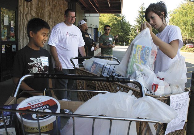 This 2009 file photo shows volunteers outside the Safeway on South 320th Street in Federal Way.