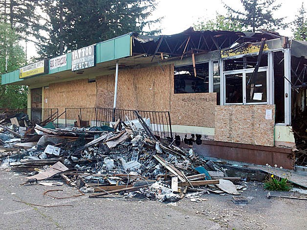 A burned building along Pacific Highway South once housed several businesses before a fire destroyed it in October. The fire was caused by an illegal marijuana grow operation.