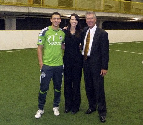 Seattle Sounders player Lamar Neagle and Wild Waves Theme Park CEO Jeff Stock worked with Kelly Maloney (center)