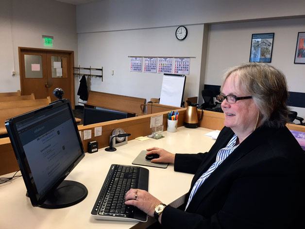 District Court Presiding Judge Donna Tucker demonstrating the online e-mitigation system now available to citizens with traffic tickets.