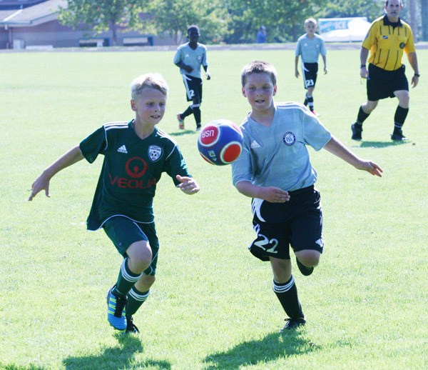 Members of the FWFC Storm ‘00 Green and Kent United ‘00 Green go after the ball during a Blast Off game Friday at Saghalie Park.