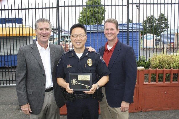 Federal Way Deputy Police Chief Andy Hwang was honored Saturday at a key ceremony at Wild Waves Theme Park. The park honored Hwang for his public service. He is pictured with CEO Jeff Stock and general manager Todd Suchan.