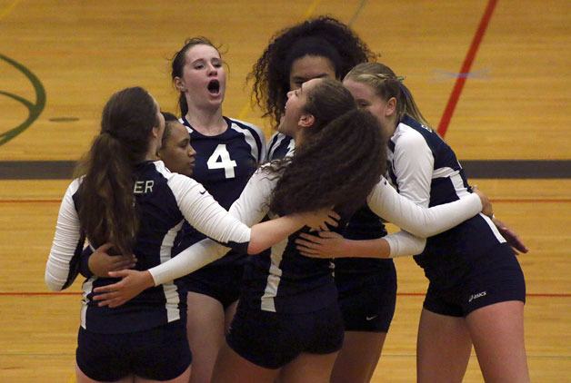 Beamer players celebrate winning the first set 25-14 against Thomas Jefferson in their 3-0 win on Monday night at Todd Beamer High School.