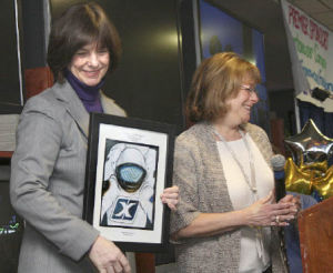 Above: Shelley Puariea of the Boys and Girls Club presents Dr. Bonnie Dunbar with a framed drawing of an astronaut at the Breakfast for Kids