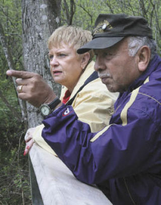 Saul and Nora Saldana observe ducks along the West Hylebos Wetlands boardwalk May 10 with the assistance of Lucia Faithfull of the Rainier Audubon Society during the Buds and Blooms festival.
