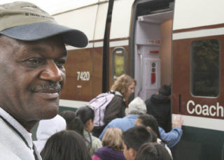 Eugene Montgomery rounds up students and chaperones from Sunnycrest Elementary School to board a train at the Amtrak station in Tacoma. The students took a ride down to Portland as a reward for reading books and behaving in school.
